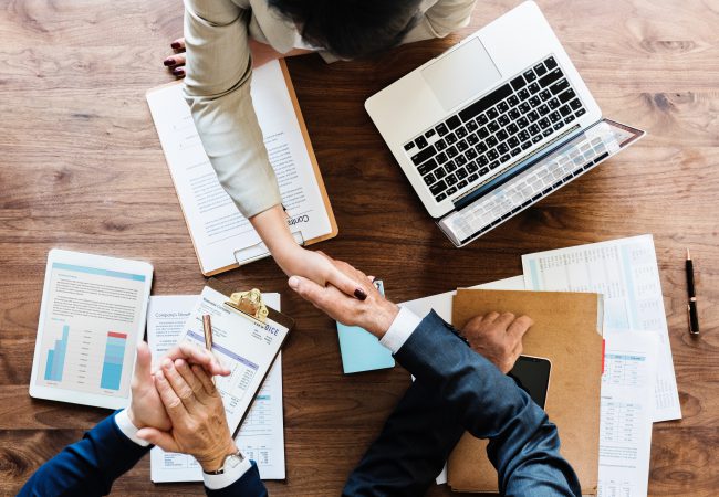 business-people-shaking-hands-together-2